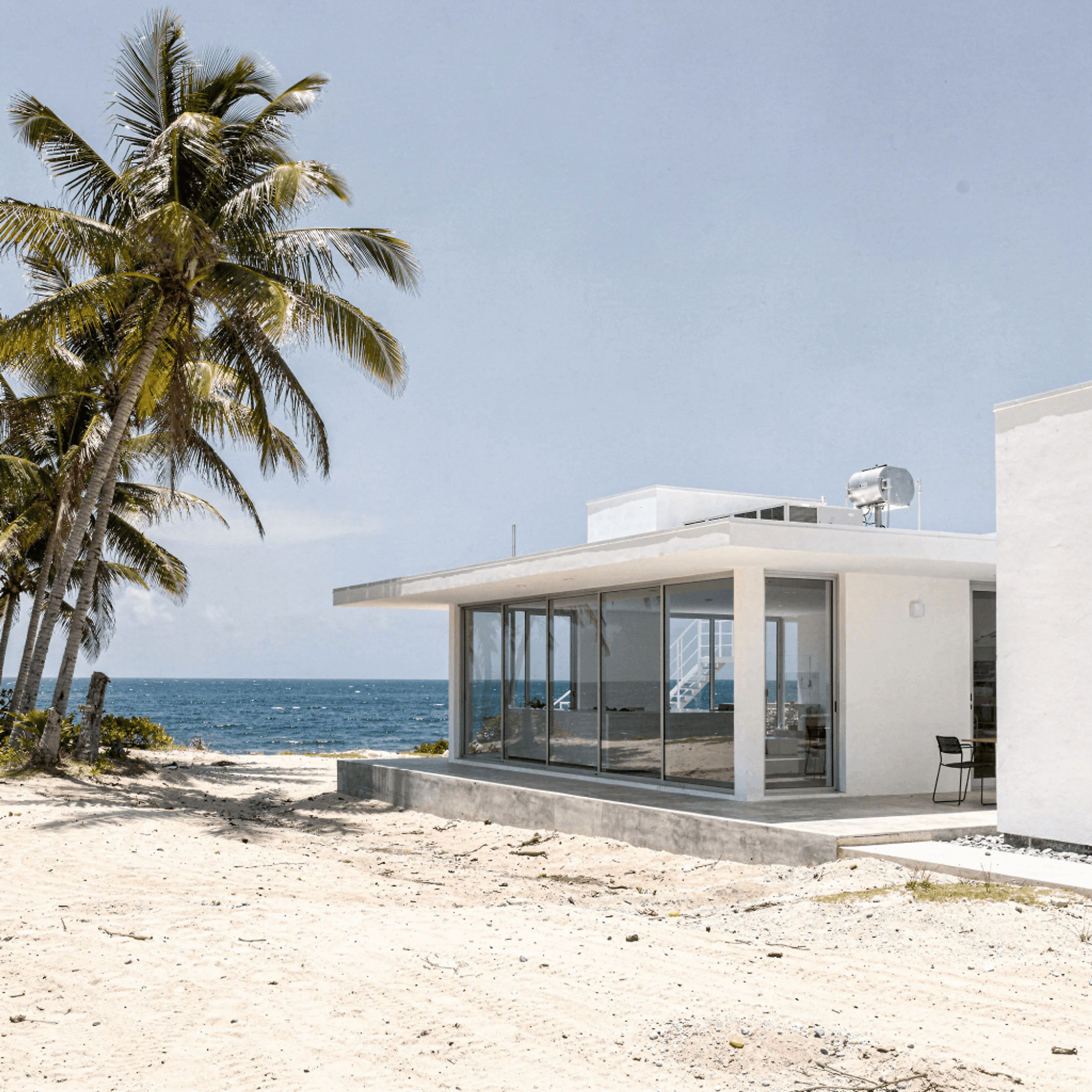 Concept rendering of a small white research building among palms at the edge of a bright sea.